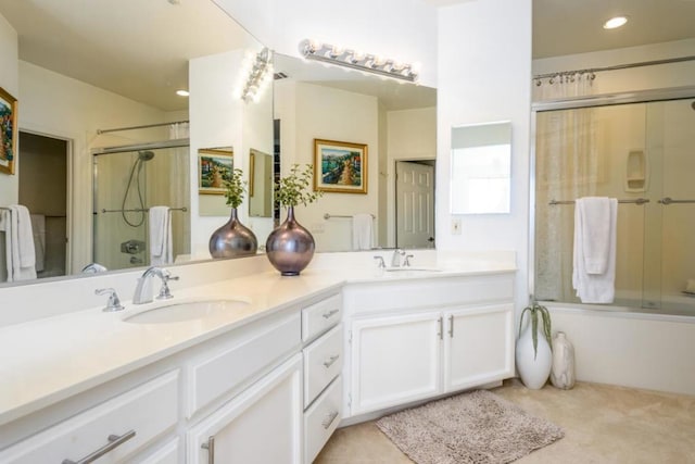 bathroom with vanity and bath / shower combo with glass door