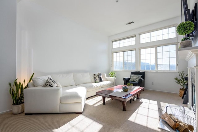 carpeted living room featuring a high end fireplace