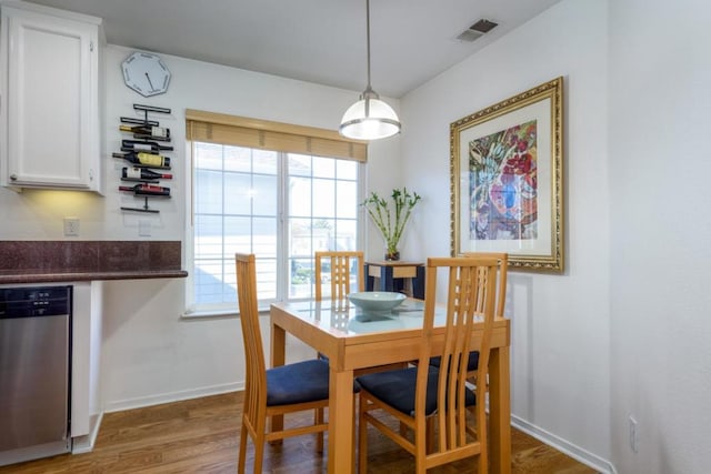 dining space featuring dark wood-type flooring