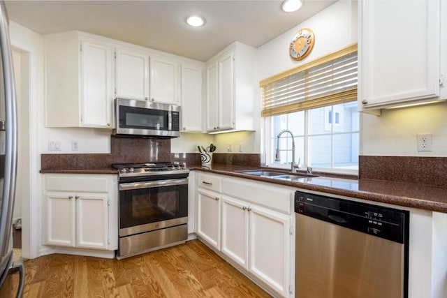 kitchen with white cabinetry, appliances with stainless steel finishes, and sink