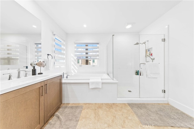 bathroom with tile patterned floors, independent shower and bath, and vanity