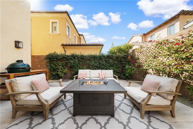 view of patio / terrace featuring grilling area and an outdoor living space with a fire pit