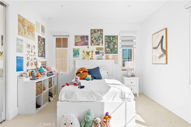 bedroom featuring light carpet