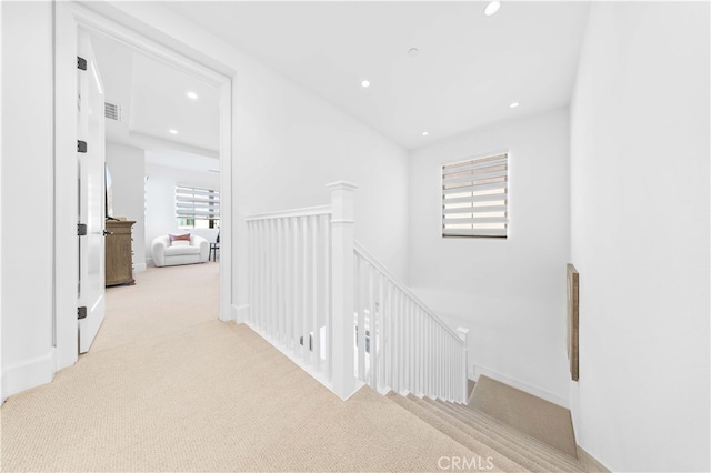 hallway with light colored carpet