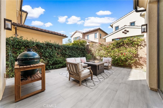 view of patio featuring an outdoor living space with a fire pit