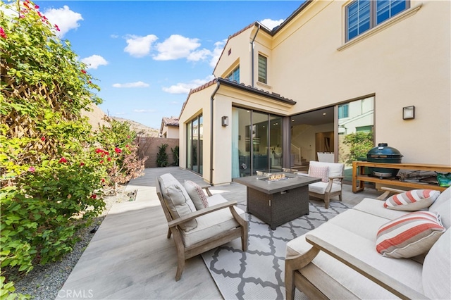 view of patio / terrace featuring an outdoor living space with a fire pit