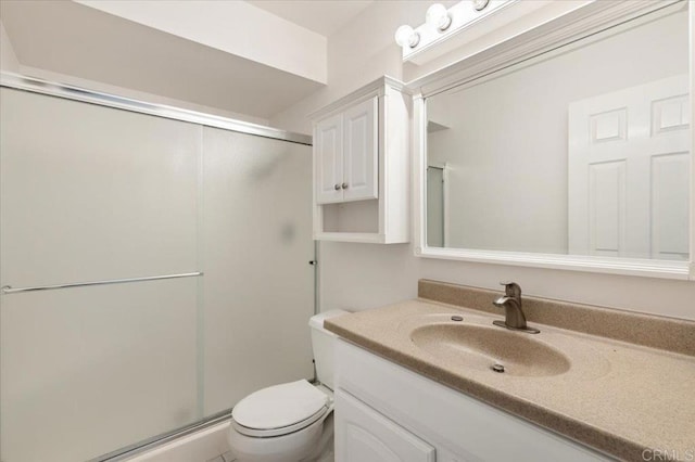 bathroom with vanity, walk in shower, and toilet