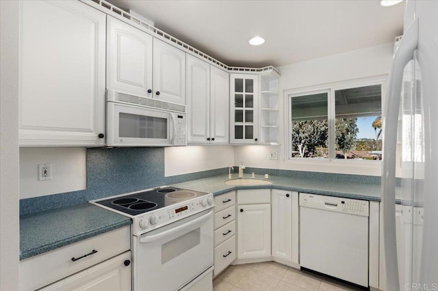 kitchen with white cabinetry, white appliances, and sink