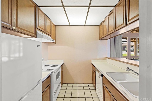 kitchen with light tile patterned flooring, white appliances, and sink