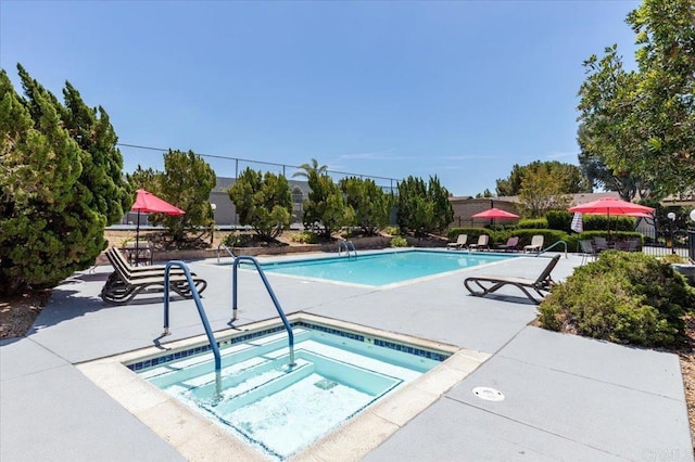 view of pool featuring a hot tub and a patio