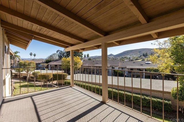 view of patio with a mountain view and a balcony