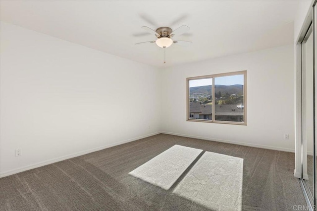 carpeted empty room with ceiling fan