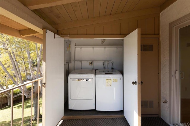 washroom with washer and dryer and wood ceiling