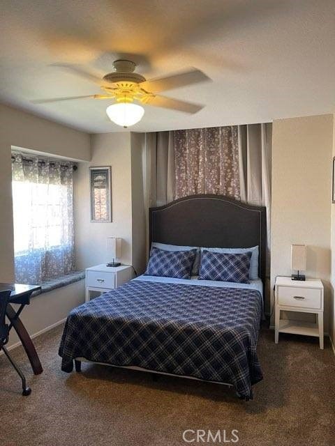 carpeted bedroom with ceiling fan