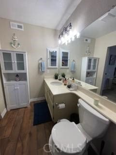 bathroom featuring vanity, toilet, and hardwood / wood-style floors