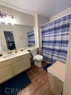 bathroom featuring vanity, hardwood / wood-style floors, and toilet