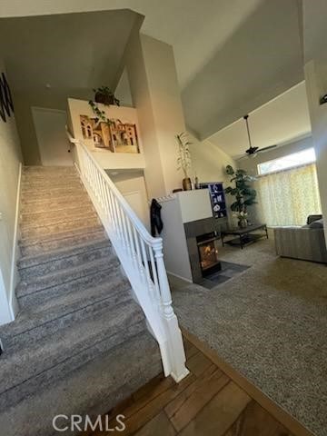 stairs with hardwood / wood-style flooring and a high ceiling