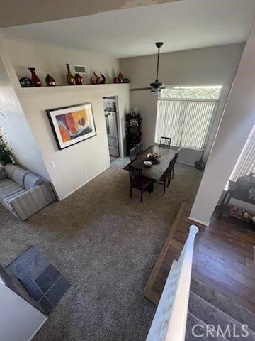 living room with dark hardwood / wood-style floors and ceiling fan