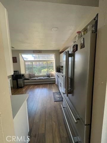 kitchen with white cabinetry, dark hardwood / wood-style floors, and high quality fridge