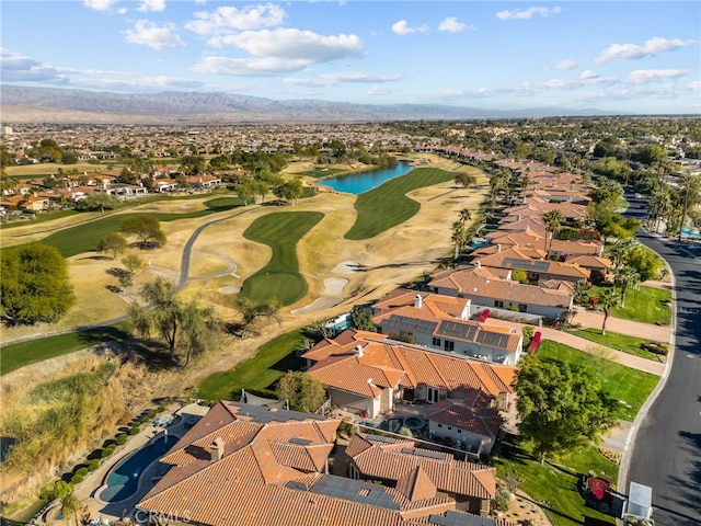 aerial view featuring view of golf course and a water and mountain view