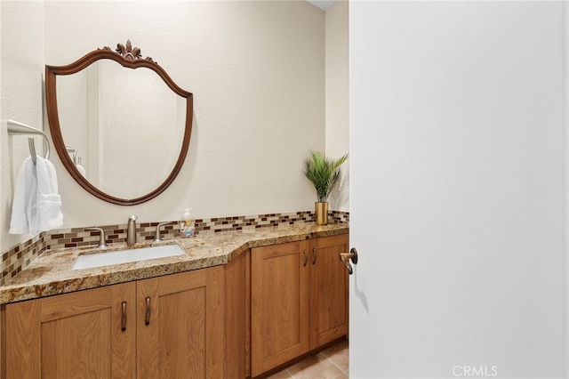 bathroom featuring tasteful backsplash, vanity, and tile patterned floors