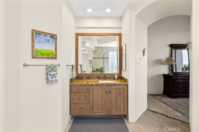 bathroom with walk in shower and vanity