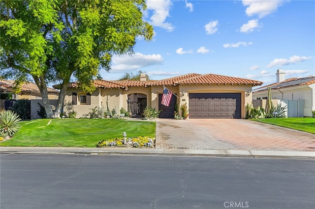 mediterranean / spanish-style home with a garage and a front yard