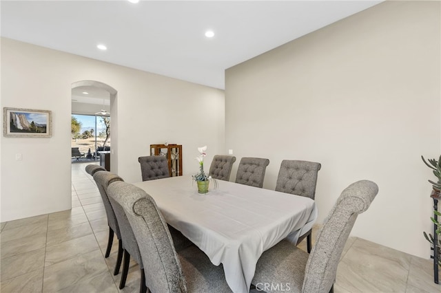 dining area with arched walkways and recessed lighting