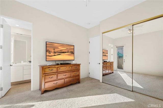 bedroom with carpet floors, a closet, and ensuite bathroom