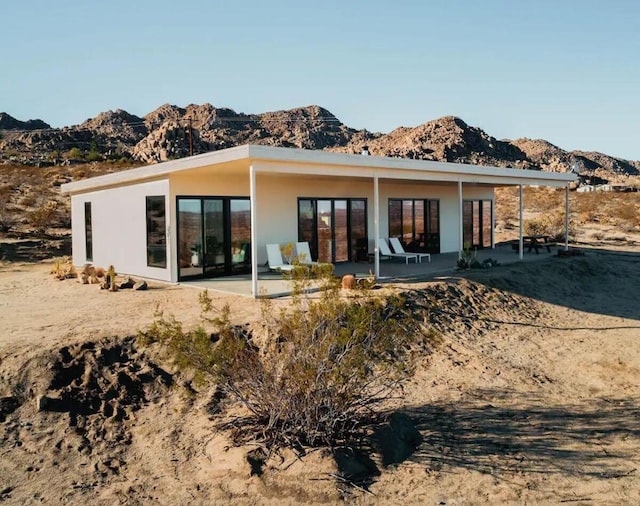 rear view of property featuring a patio and a mountain view