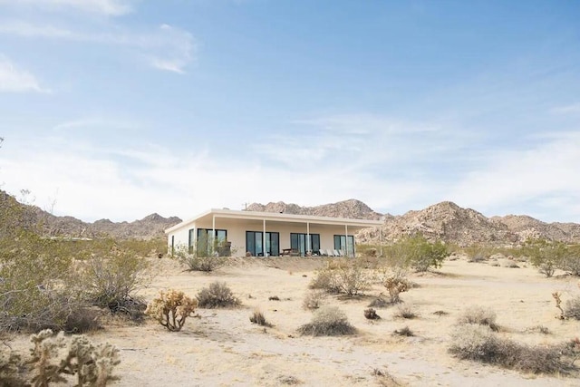 rear view of property featuring a mountain view