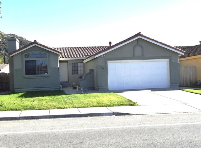 view of front of property with a garage and a front yard