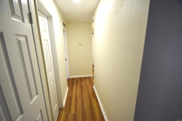 hall with dark wood-type flooring