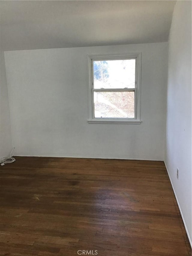 unfurnished room with dark wood-style floors