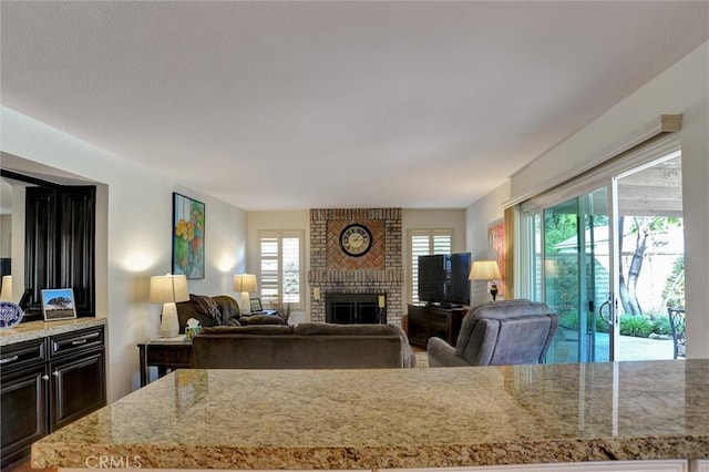 living room featuring a brick fireplace