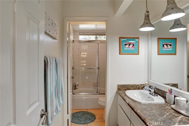 full bathroom with toilet, vanity, shower / bath combination with glass door, and tile patterned flooring