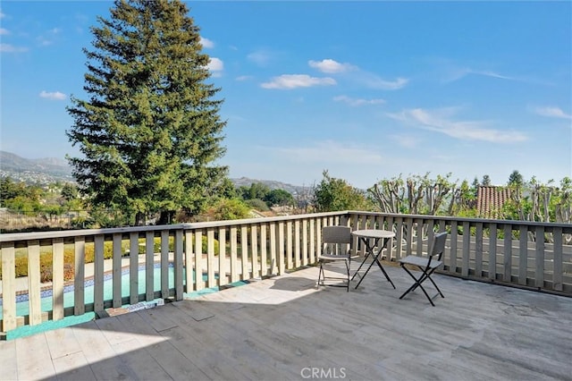 wooden deck with a mountain view