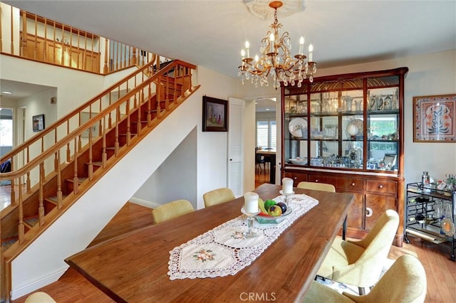 dining room featuring a notable chandelier, plenty of natural light, and light hardwood / wood-style floors