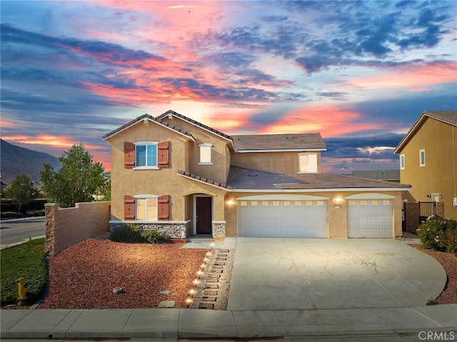 view of front facade featuring a garage and a mountain view