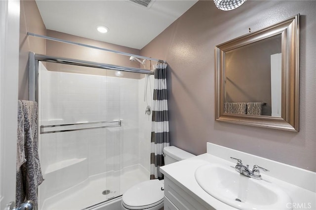 bathroom with toilet, vanity, and a shower with curtain