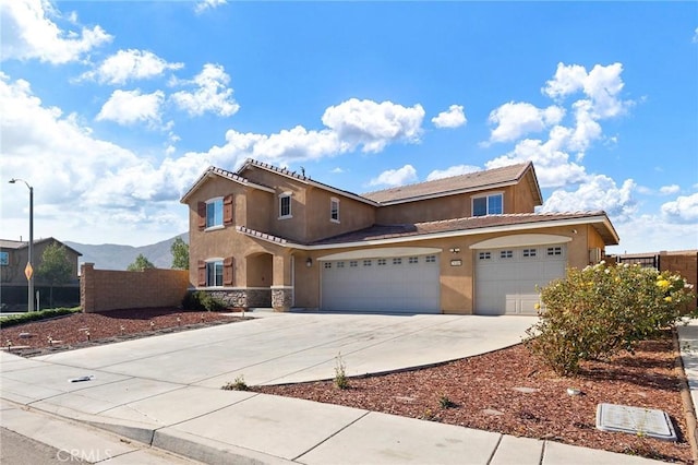 view of front of home with a garage and a mountain view