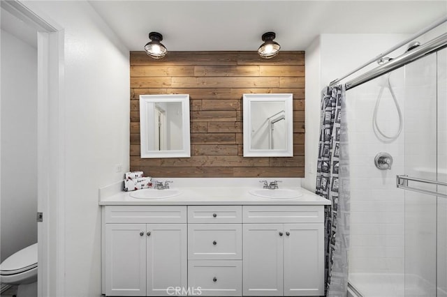 bathroom with vanity, toilet, curtained shower, and wood walls