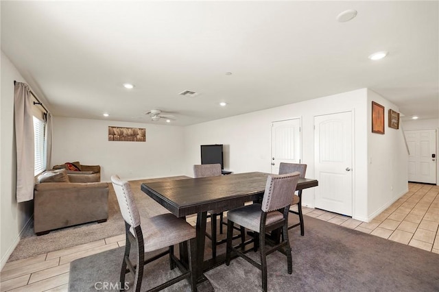 tiled dining space with ceiling fan