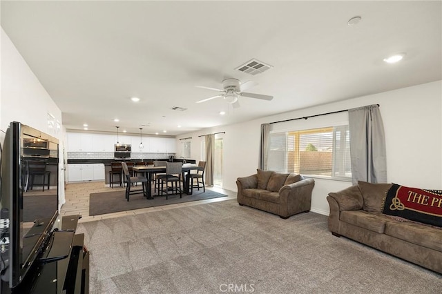 living room featuring ceiling fan and light carpet