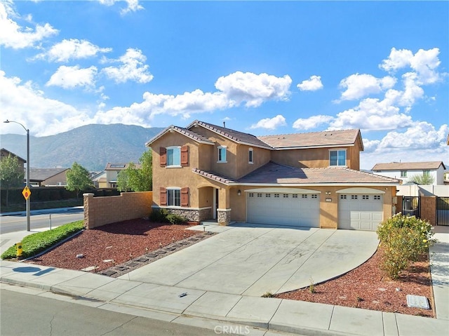 view of front of property with a mountain view and a garage