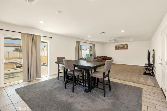 tiled dining space featuring ceiling fan