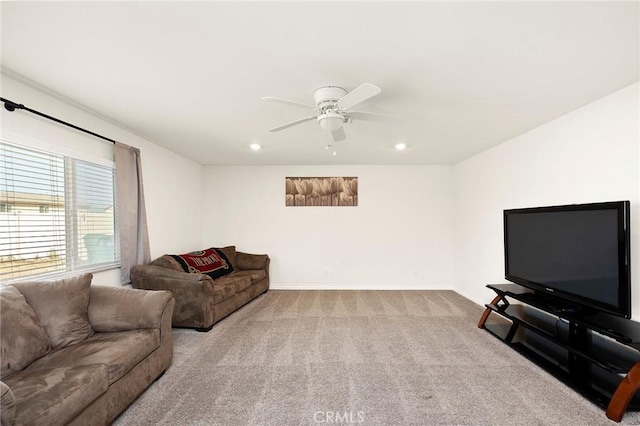 carpeted living room with ceiling fan