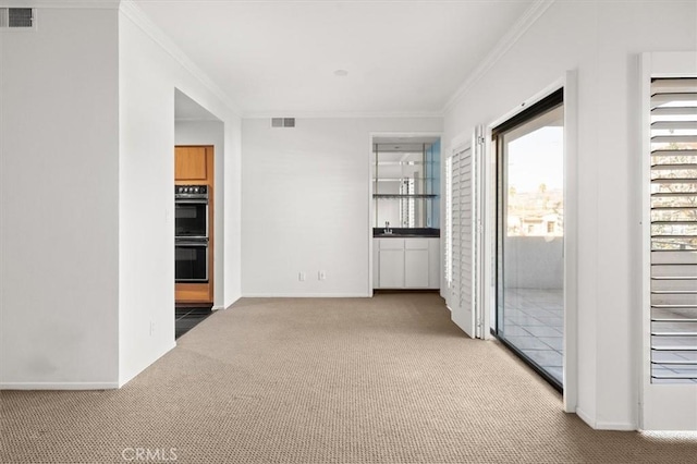 interior space with crown molding and light colored carpet