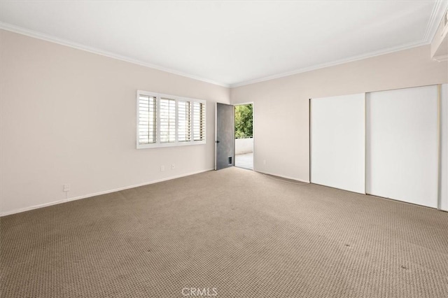 unfurnished bedroom featuring crown molding, carpet floors, and a closet