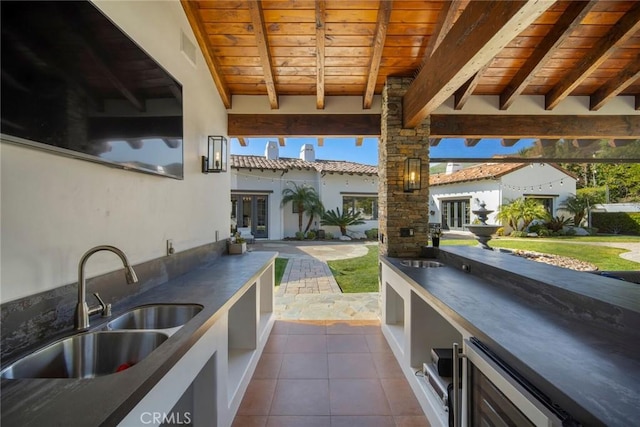 view of patio featuring area for grilling, sink, and wine cooler